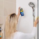 What removes hard water stains from glass shower doors?